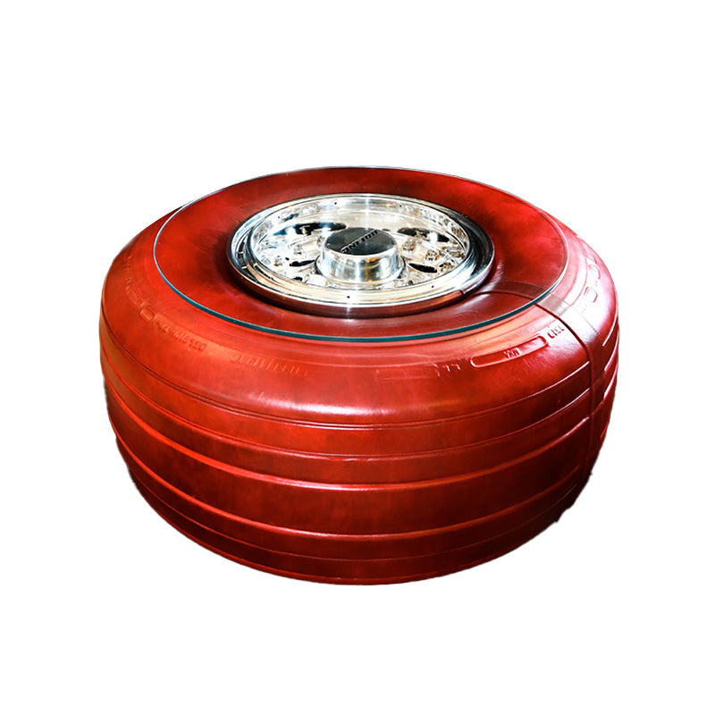 A Boeing 747 wheel coffee table with tire wrapped in red leather.